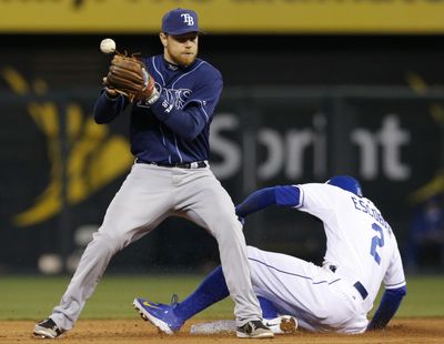 Rays second baseman Ben Zobrist bobbles the ball as the Royals’ Alcides Escobar slides into second base. (Associated Press)