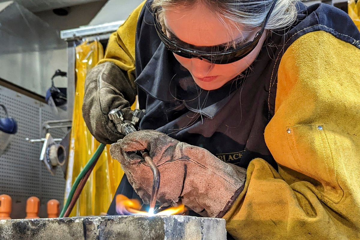 Clear Lake High School senior Emma Pingel uses an acetylene torch to cut steel plates in her industrial-tech class in Clear Lake, Iowa. pm Dec. 1, 2021.  (Associated Press )