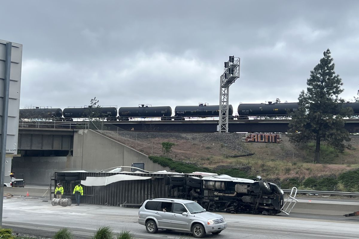 An eastbound semitruck tipped on its side Wednesday morning on Interstate 90 just east of where the freeway goes over Latah Creek.  (Jonathan Brunt/The Spokesman-Review)