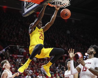 In this March 3, 2020, file photo, Maryland’s Jalen Smith (25) dunks as Rutgers’ Myles Johnson (15) watches during the first half of an NCAA college basketball game in Piscataway, N.J. (John Minchillo / Associated Press)