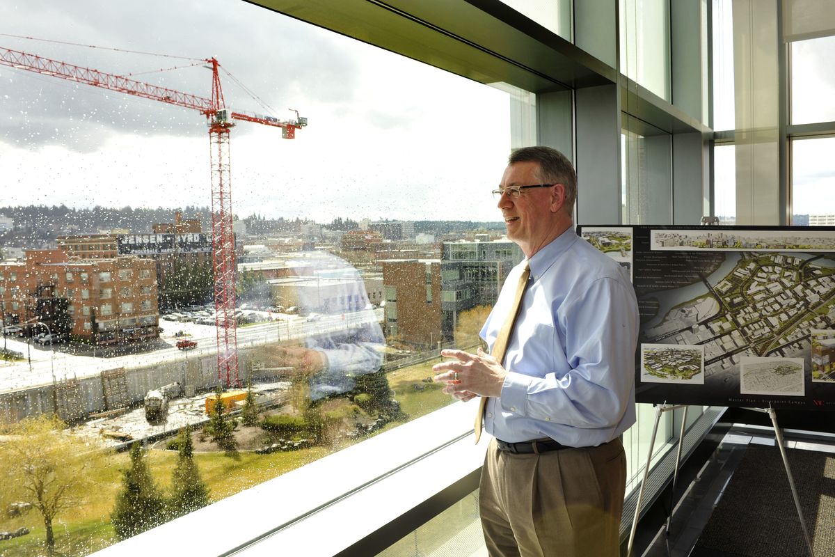 Dr. Brian Pitcher, chancellor of the Washington State University Spokane campus, looks out recently on construction of the Biomedical and Health Sciences Building. The $78.6 million project is the first part of a multiphase research complex.