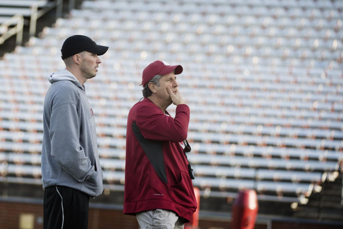 WSU defensive coordinator Alex Grinch, left, watches players with head coach Mike Leach on March 31 at Martin Stadium. (Tyler Tjomsland / The Spokesman-Review)