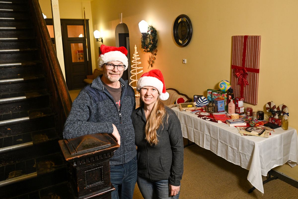 Adam and Heidi Murphy stand in their home, a historic schoolhouse in Latah, at which they will operate a pop-up gift shop where kids can shop for their parents the weekend before Christmas. They’ve begun setting out tables with donated items so kids can separate and look through the items away from other shoppers.  (Jesse Tinsley/THE SPOKESMAN-REVIEW)