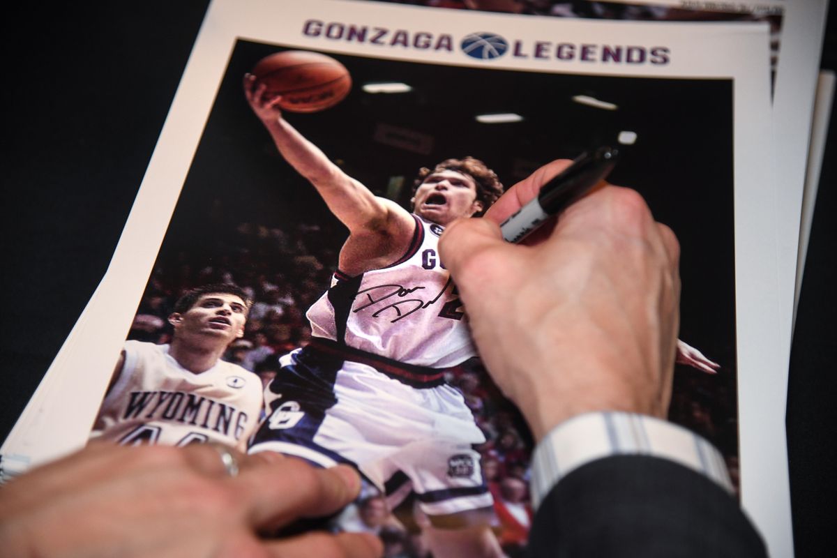 Dan Dickau signs his poster for a fan after the Gonzaga Legends event, Monday, Nov. 5, 2018. (Dan Pelle / The Spokesman-Review)