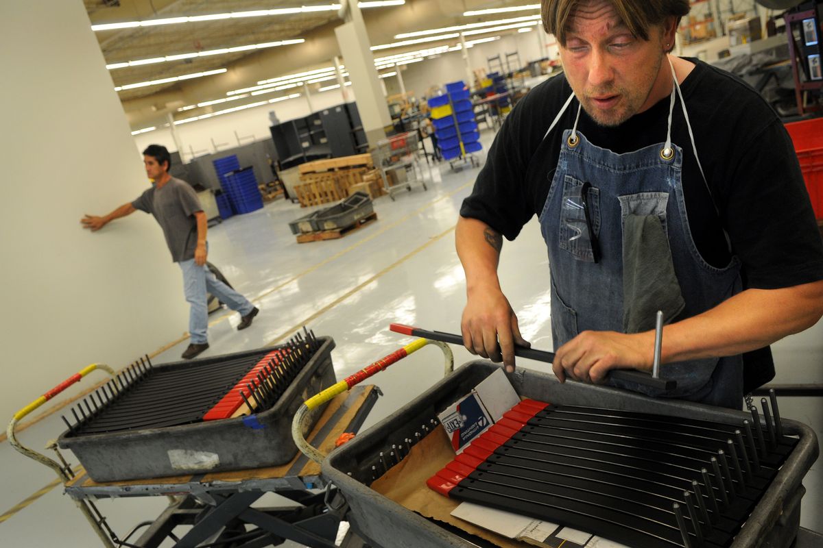 Kurt Lantz assembles blades for paper cutters at Lighthouse for the Blind as Don Hardin finds his way around the factory floor Monday at Lighthouse, a company in Spokane that hires people who are blind or partially blind.  (Photos by RAJAH BOSE / The Spokesman-Review)