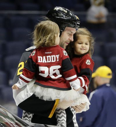 Pacific Division forward John Scott carries his children onto the ice after being named the most valuable player in the NHL hockey All-Star games Sunday, Jan. 31, 2016, in Nashville, Tenn. (Associated Press / Associated Press)