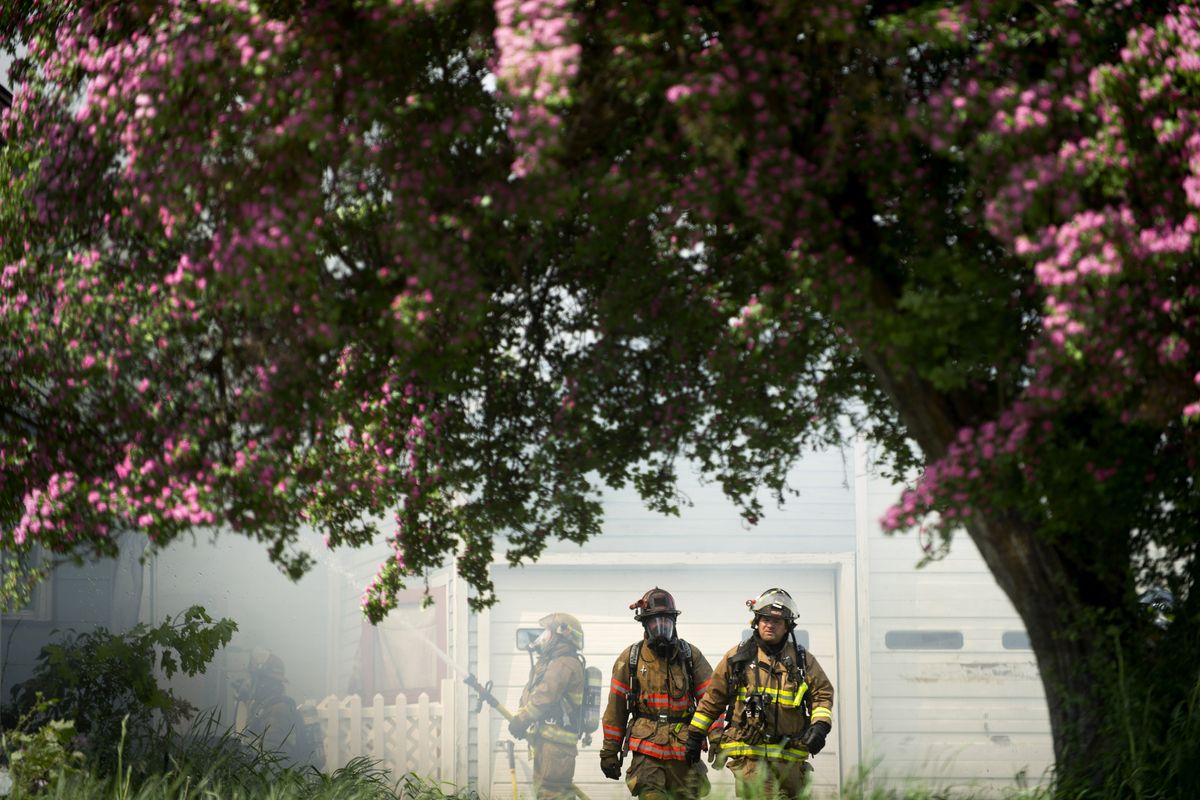 Firefighters respond to a house fire on Saturday, June 2, 2012, near downtown Medical Lake, Wash. (Tyler Tjomsland / The Spokesman-Review)