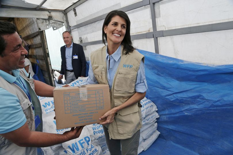 In this May 24 photo, U.S. Ambassador to the U.N. Nikki Haley holds a food parcel provided by the World Food Programme, part of the humanitarian aid shipments into Syria, during a visit at the Reyhanli border crossing with Syria, near Hatay, southern Turkey. Haley is presenting another side of President Donald Trump’s America First doctrine, one that focuses on human rights and humanitarian assistance. (Burhan Ozbilici / Associated Press)