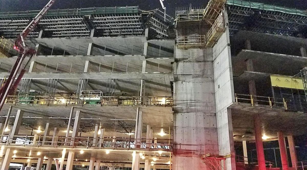 This shows the collapsed scaffolding, top center, at a hotel under construction after two workers fell to their deaths early Wednesday, Aug. 29, 2018, near Orlando, Fla. (Associated Press)