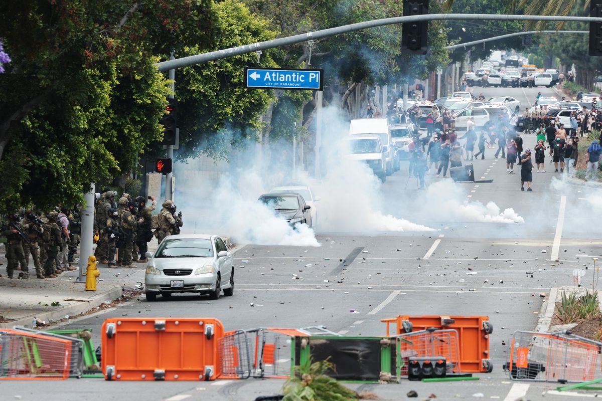 People block off the street and set a fire during protests against ICE and immigration raids on Saturday in Paramount, Calif. (Myung J. Chun/Los Angeles Times/TNS)