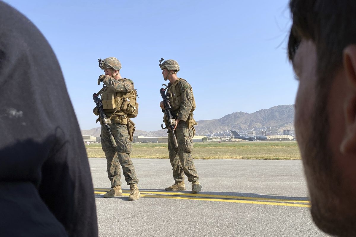 U.S soldiers stand guard along a perimeter at the international airport in Kabul, Afghanistan, Monday, Aug. 16, 2021. On Monday, the U.S. military and officials focus was on Kabul’s airport, where thousands of Afghans trapped by the sudden Taliban takeover rushed the tarmac and clung to U.S. military planes deployed to fly out staffers of the U.S. Embassy, which shut down Sunday, and others. (Shekib Rahmani)
