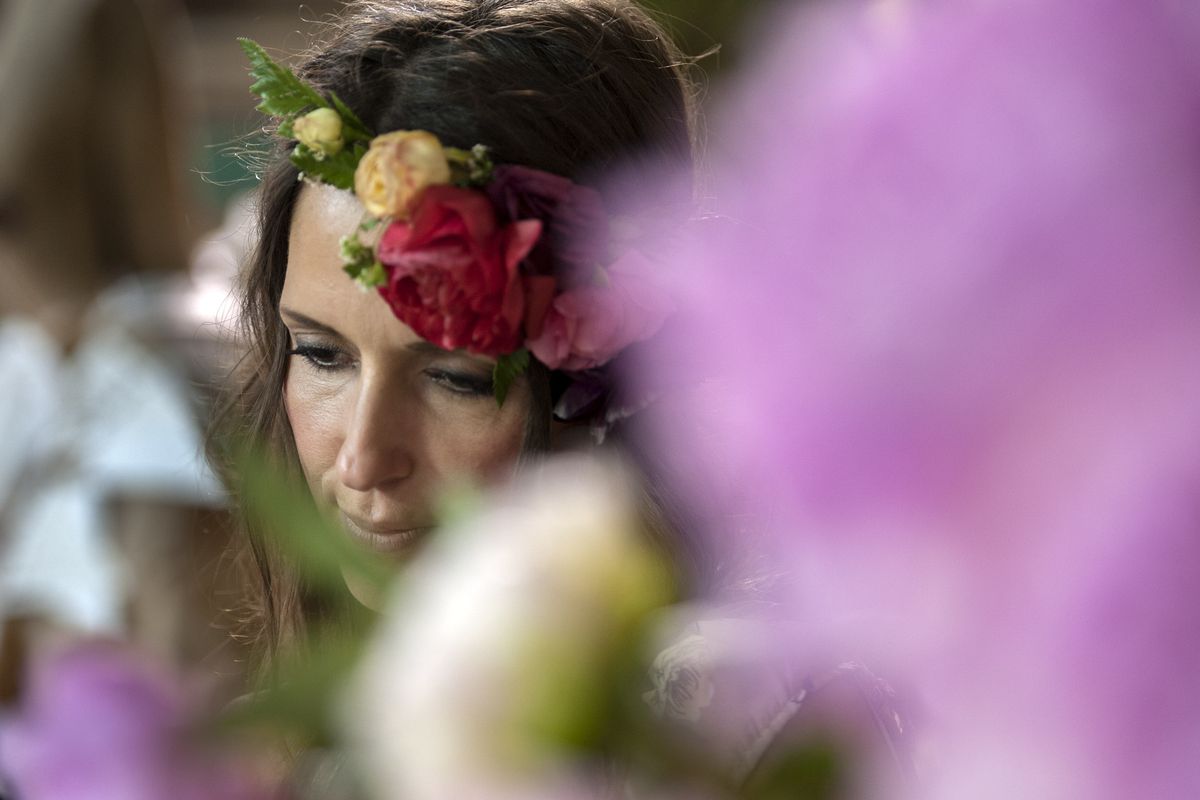 Shawn Chamberlain, owner of Flower Bar, arranged flower tiaras and bouquets during the Farm Chicks Fair at the Spokane County Fairgrounds on June 4, 2017.  (Kathy Plonka/The Spokesman-Review)