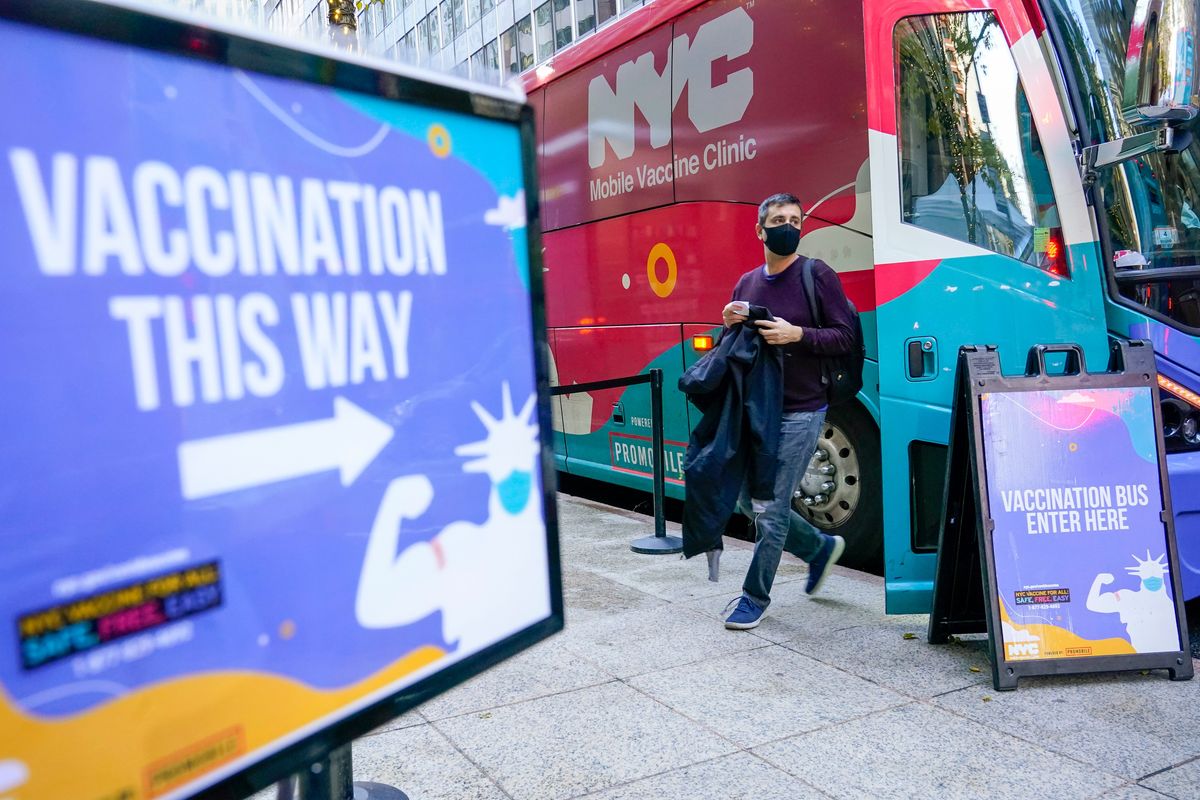 A man walks off a vaccination bus at a NYC mobile vaccine clinic in midtown Manhattan on Monday.  (Mary Altaffer)