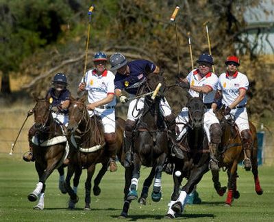 
Eric Dix, center, and Rob Peterson, second from right, fight for position during the second chukker of polo Sunday at the Spokane Polo Grounds. 
 (Photos by Joe Barrentine / The Spokesman-Review)