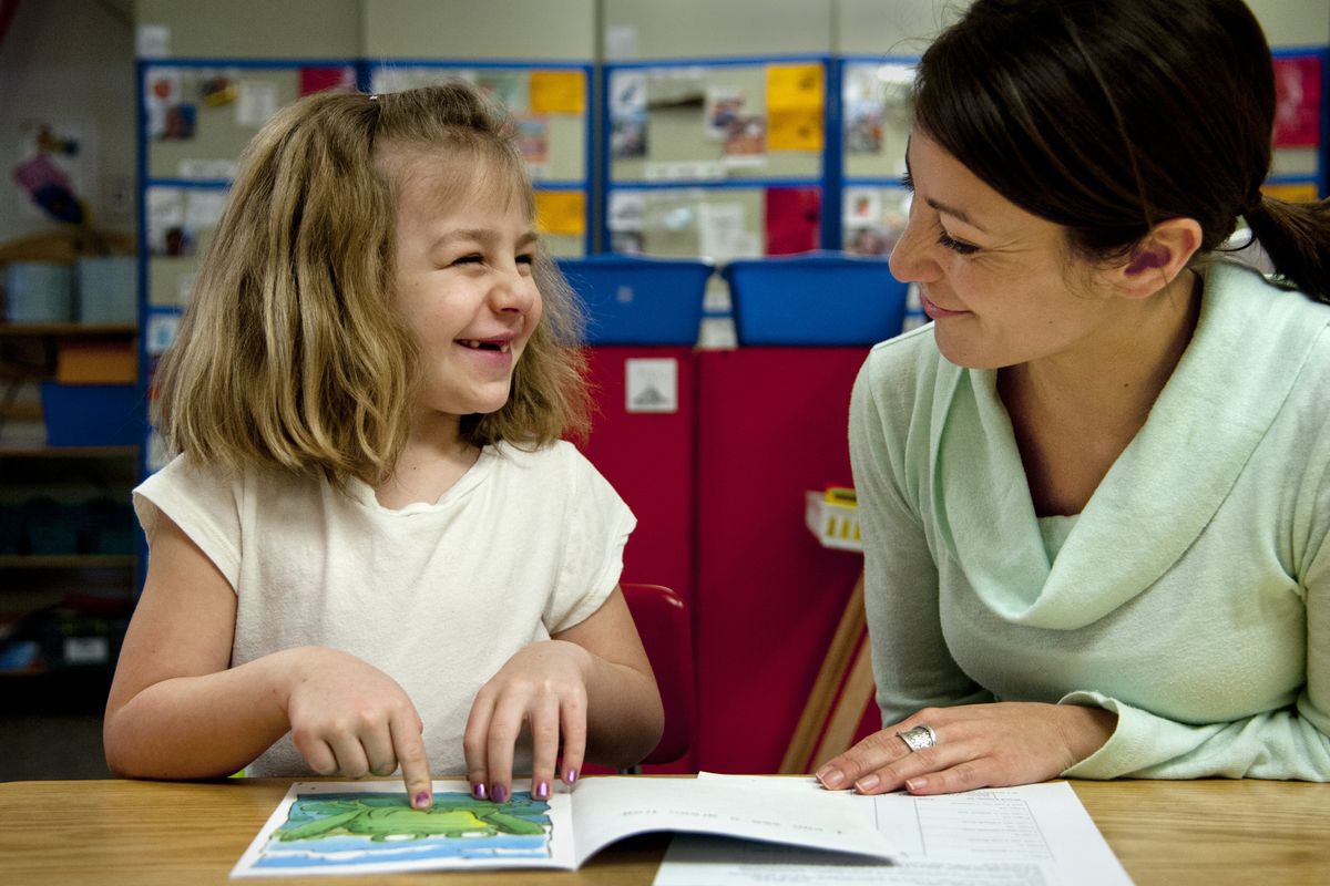 Holmes Elementary kindergartner Cali Haley beams after giving an answer to teacher Angela Ozuna during a reading assessment Tuesday. Ozuna and colleague Emily Sobczuk were among teachers in the state who assessed kindergartners on a variety of abilities. (Dan Pelle)