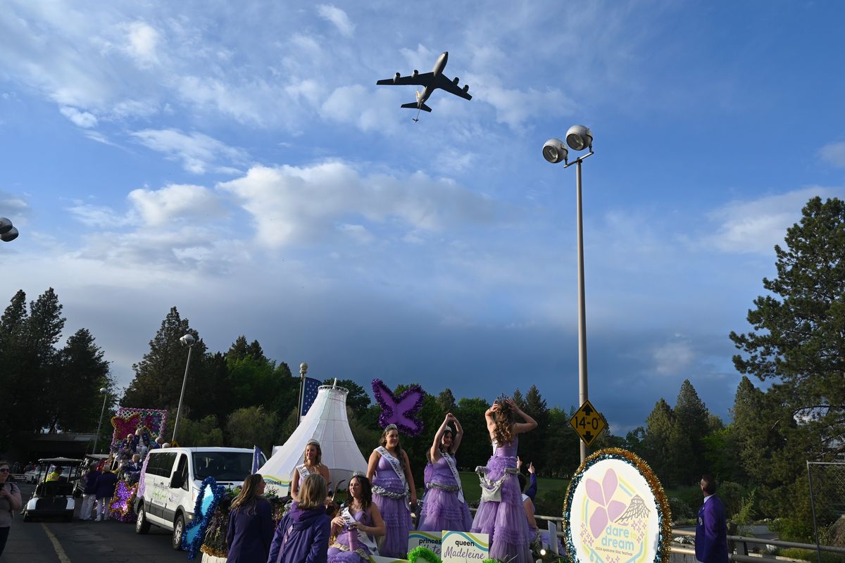 An Air Force KC-135 tanker aircraft roars overhead as the annual Lilac Festival’s Armed Forces Torchlight Parade, with the Lilac Festival queen and her court on their float, begins moving last May into downtown Spokane. (JESSE TINSLEY)