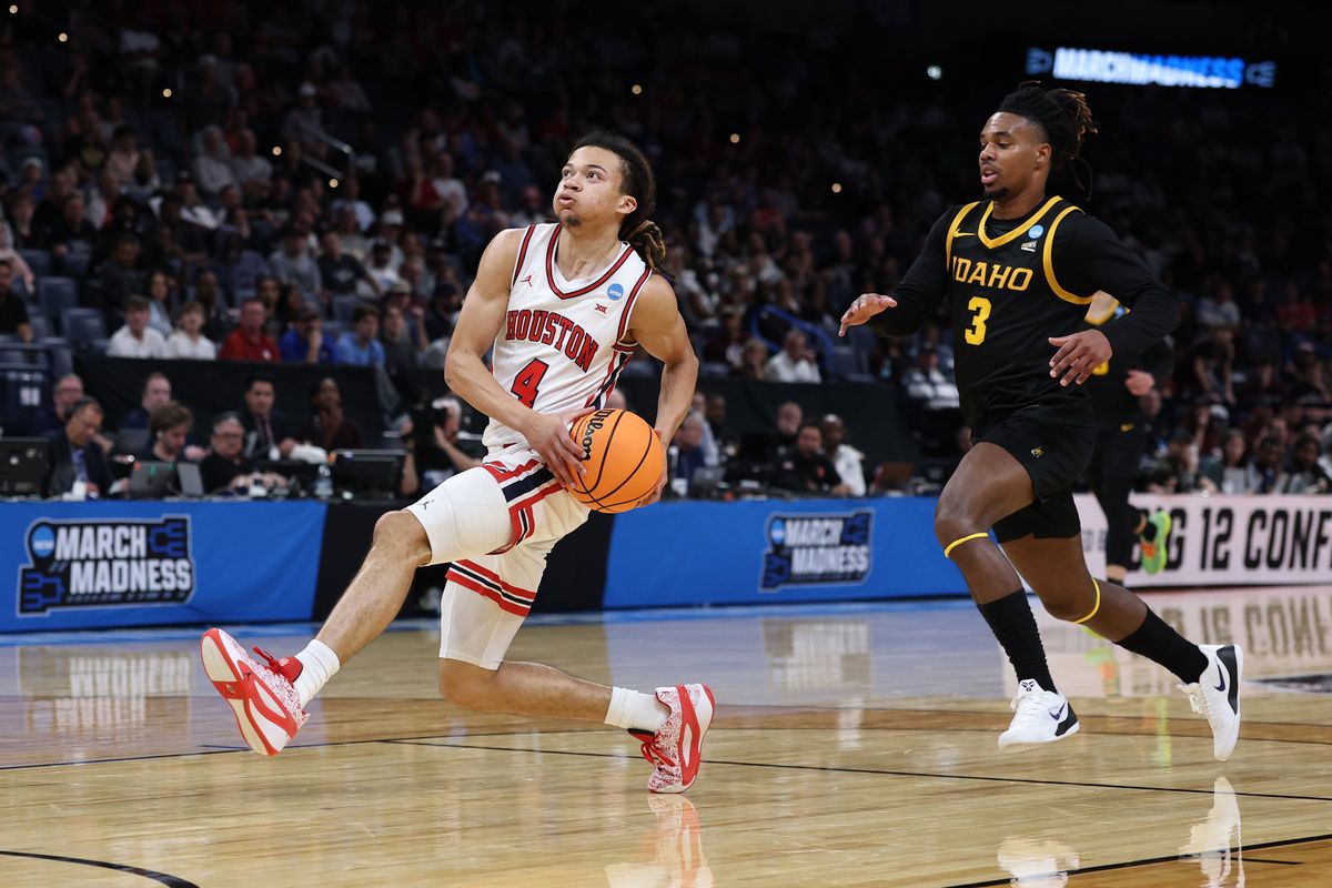 Houston guard Kingston Flemings drives to the basket past Idaho
