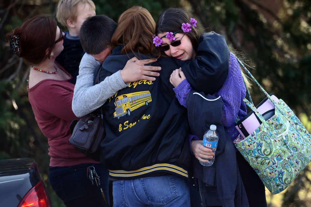 Parents and students embrace along School Road near Franklin Regional High School after more than a dozen students were stabbed by a knife wielding suspect at the school on Wednesday, April 9, 2014, in Murrysville, Pa., near Pittsburgh. The suspect, a male student, was taken into custody and is being questioned. (Sean Stipp / Tribune Review)