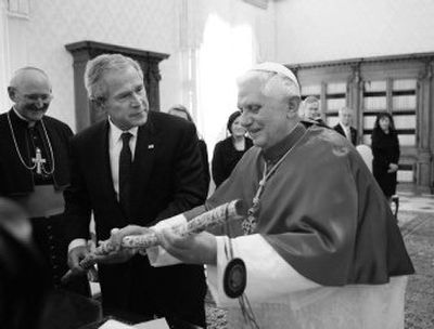 
 President Bush presents Pope Benedict XVI with a walking stick made by a former homeless man in Dallas during a meeting Saturday at the Vatican. 
 (Associated Press photos / The Spokesman-Review)