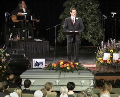 
A photograph of Kelly James rests on his casket as his older brother Frank James delivers a eulogy Wednesday at Fellowship Baptist Church in Dallas. More than 500 people attended the funeral for the climber whose body was recovered from Oregon's Mount Hood. 
 (Associated Press / The Spokesman-Review)