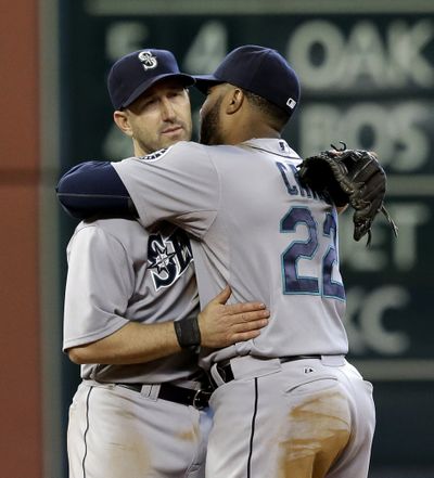Mariners Robinson Cano, right, and Willie Bloomquist embrace after beating the Astros 8-7 in Houston. (Associated Press)