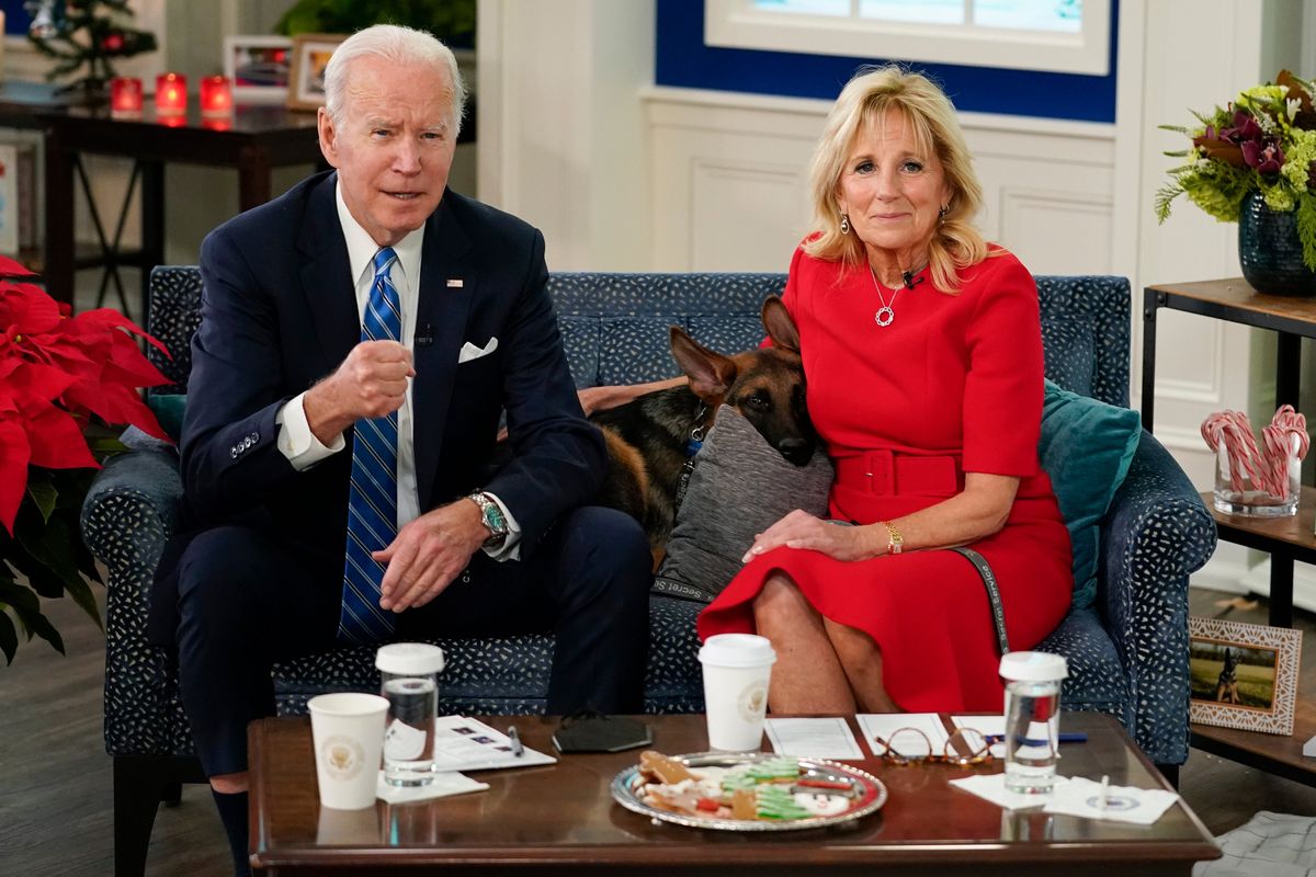 President Joe Biden, first lady Jill Biden and their new dog Commander, a purebred German shepherd puppy, meet virtually with service members around the world, Saturday, Dec. 25, 2021, in the South Court Auditorium on the White House campus in Washington, to thank them for their service and wish them a Merry Christmas.  (Carolyn Kaster)