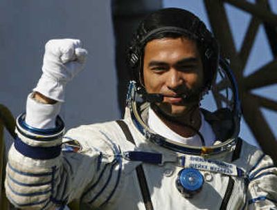 
Malaysian  astronaut Sheikh Muszaphar Shukor  gestures  before taking off Wednesday for the International Space Station. Associated Press
 (Associated Press / The Spokesman-Review)