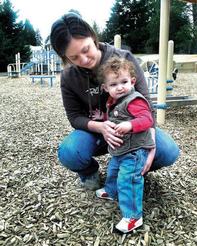 
Rachelle Bec comforts her son, Tristan, on a Bellevue, Wash., playground Wednesday. The child was one of two boys nipped by a coyote Tuesday. 
 (Associated Press / The Spokesman-Review)