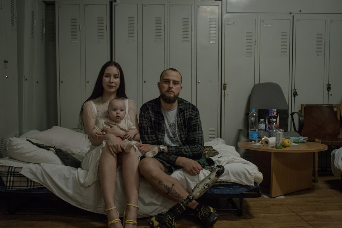 Valeriya Tkachenko, who continued her studies in ecology and education even as her husband, Vladislav, right, underwent treatment and rehabilitation after losing a leg in the battle for Azovstal, in Kyiv, Ukraine on July 20, 2023. (Laura Boushnak/The New York Times)