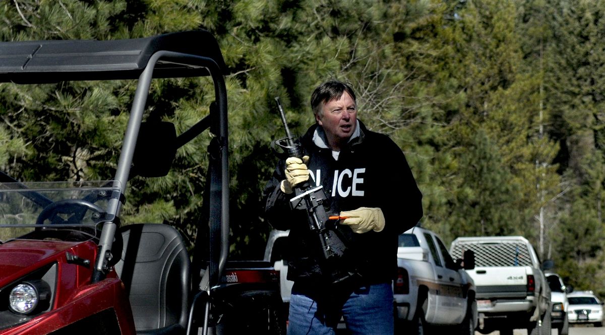 Idaho State Police Detective Terry Morgan holds a weapon seized from where Chad Lee Moore, 35, was found dead of an apparent self-inflicted gunshot wound Wednesday, March 10, 2010, in Hayden. Police had been looking for Moore in connection with a fatal shooting at a Hayden apartment complex Tuesday. (Kathy Plonka / The Spokesman-Review)