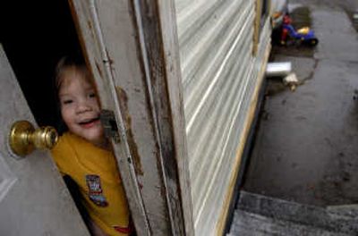 Chase Larson, 2, answers the door of his family's trailer at the El Rancho Mobile Home Park on Monday. His mother, Cat Foster, is looking for a new place to live.
(Kathy Plonka / The Spokesman-Review)