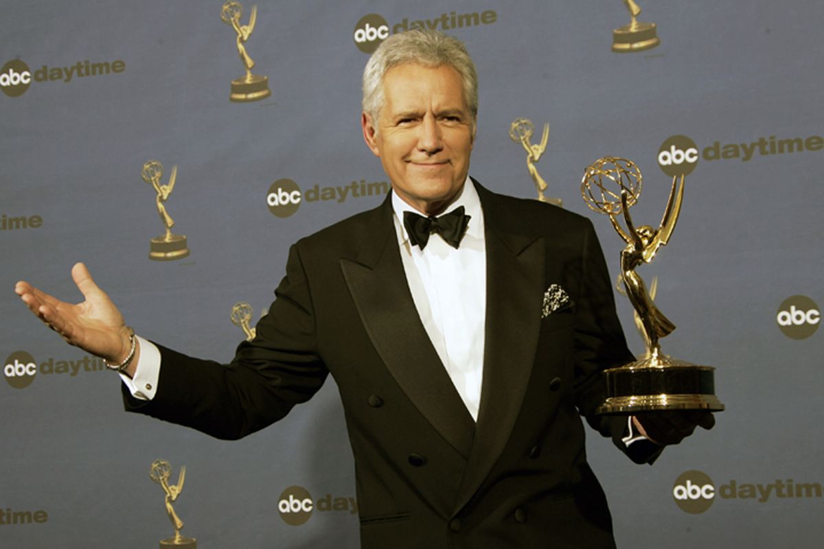 In this Friday, April 28, 2006, photo, Alex Trebek holds the award for outstanding game show host for his work on "Jeopardy!" backstage at the 33rd Annual Daytime Emmy Awards in Los Angeles. Jeopardy!” host Trebek died Sunday after battling pancreatic cancer for nearly two years. Trebek died at home with family and friends surrounding him, “Jeopardy!” studio Sony said in a statement. Trebek presided over the beloved quiz show for more than 30 years. (Reed Saxon/Associated Press)