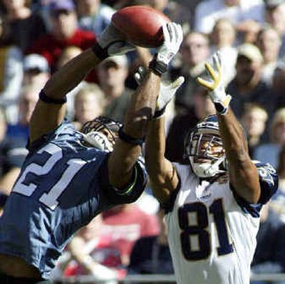 
Seattle's Ken Lucas intercepts a pass intended for St. Louis receiver Torry Holt (81) in the first quarter Sunday.
 (Associated Press / The Spokesman-Review)