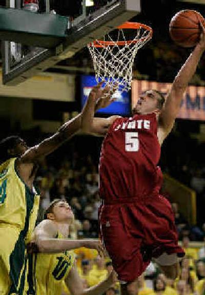 
Washington State's Chris Schlatter (5) rises for a shot against the defense of Oregon's Brandon Lincoln, left, and Maarty Leunen, center. 
 (Associated Press / The Spokesman-Review)