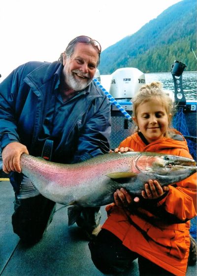 Sophie Egizi, 8, of Sandpoint, poses with her catch-and-release record-breaking Gerrard rainbow trout on Oct. 11, 2019. Egizi, who’s joined by Capt. Bob Wiley of Pend Oreille Charters, named the fish “Old Man Sparkles.” (Bob Egizi / COURTESY)