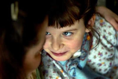 
Savannah Fitzgerald, 8, gets a hug from her mother, Brandee Marshall, at their home in Coeur d'Alene on Tuesday. Savannah was hospitalized recently after she accidently ate lye, an ingredient her mother uses to make soap.
 (Kathy Plonka / The Spokesman-Review)