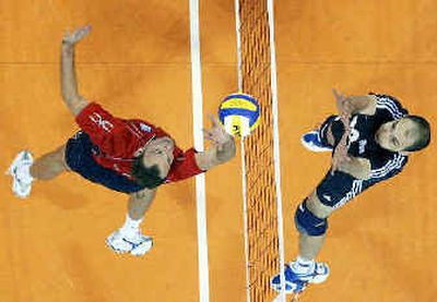 
USA's Lloy Ball, left, and Greece's Tontor-Zlatko Baev go up for a ball at the net during their volleyball quarterfinal round match that the USA won. 
 (Associated Press / The Spokesman-Review)