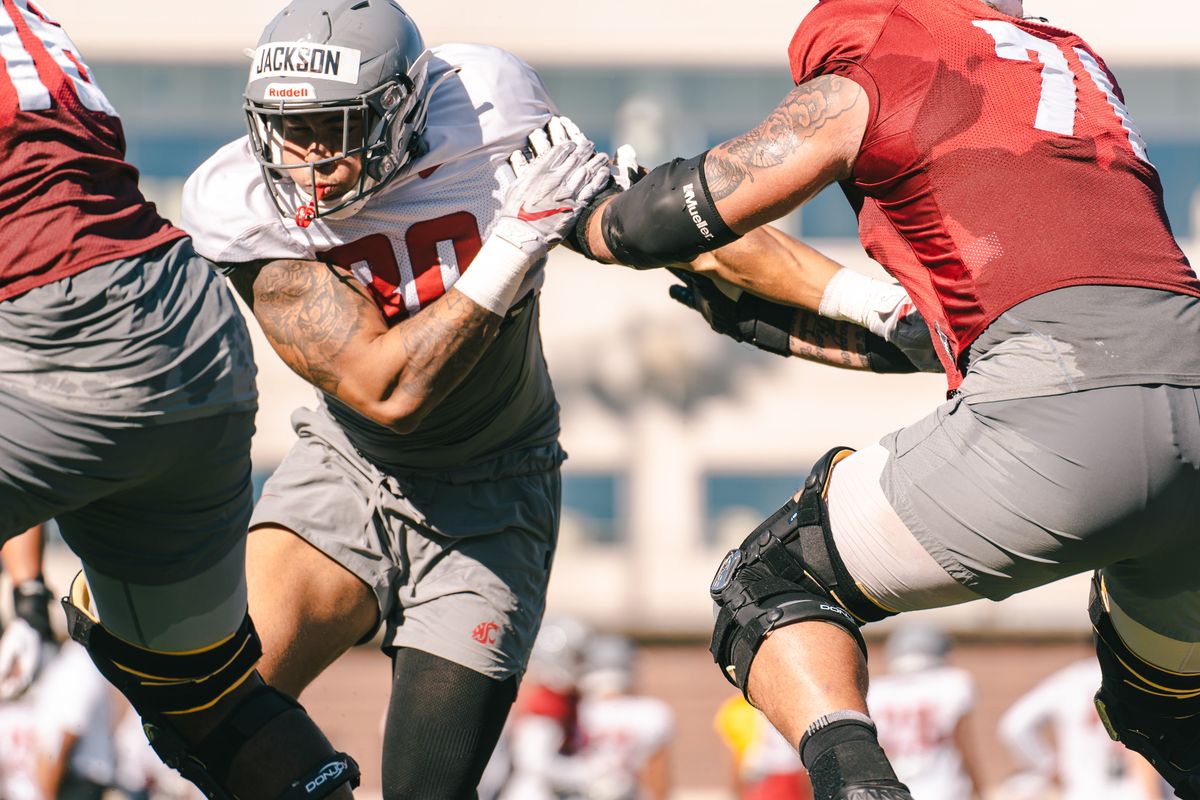Washington State edge-rusher Brennan Jackson fights off a block during a recent preseason practice at Rogers Field in Pullman.  (WSU Athletics)