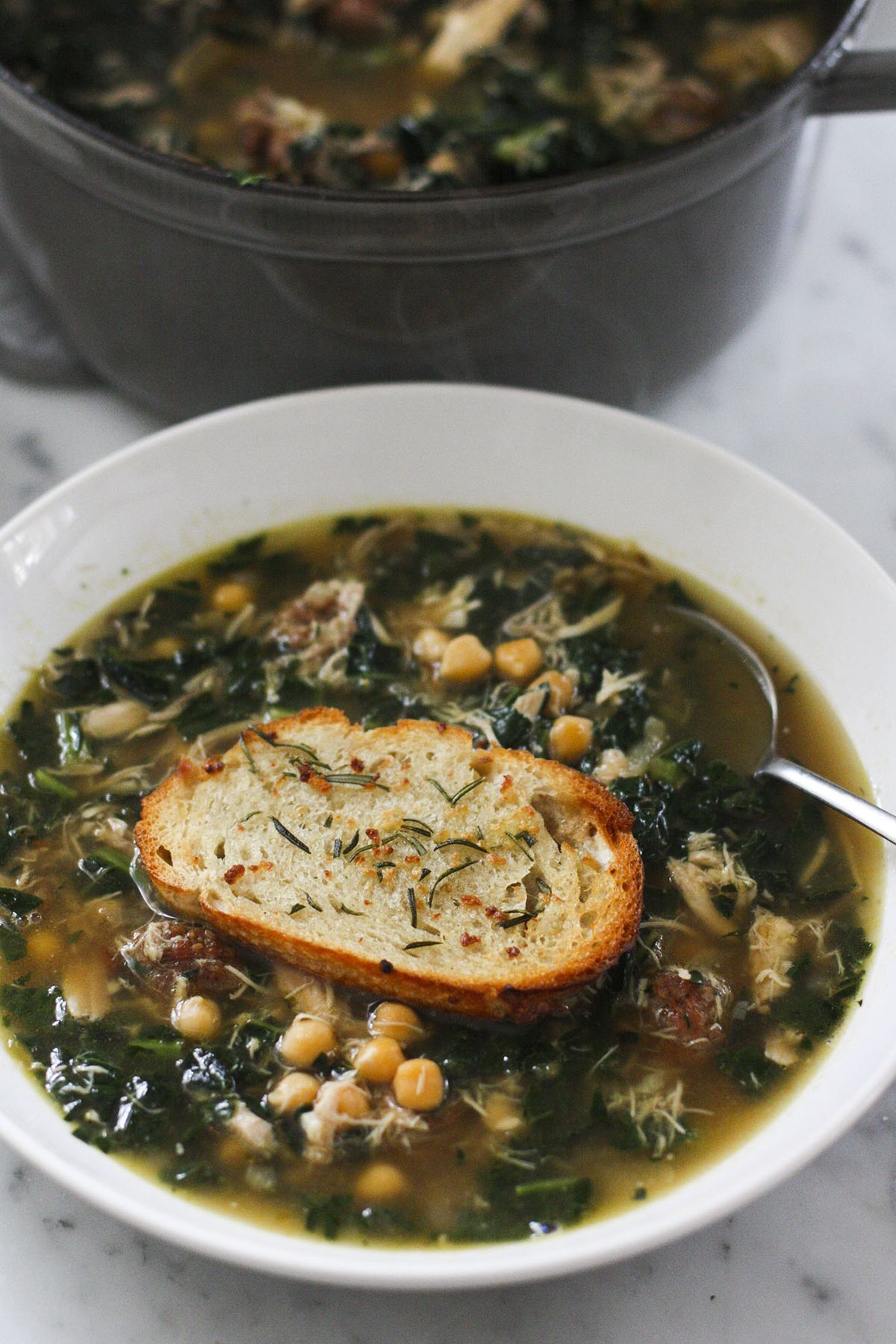 This hearty chickpea soup, topped with a homemade rosemary crouton, includes chicken, sausage and kale.