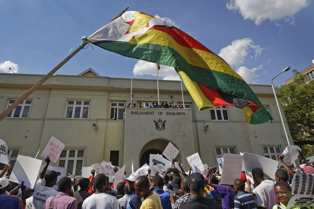 Protesters calling for the impeachment of President Robert Mugabe demonstrate outside the parliament building in downtown Harare, Zimbabwe Tuesday, Nov. 21, 2017. (Ben Curtis / Associated Press)