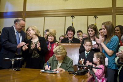 Gov. Chris Gregoire signs a bill extending unemployment benefits in Olympia on Monday. To her left are Steve Conway, D-Tacoma, and Sen. Jeanne Kohl-Welles, D-Seattle. Second from right are Heather Reeber and her children, Brianna, 15, Gavin, 9, and Kaitlyn, 5.  (Associated Press / The Spokesman-Review)