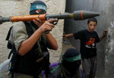 
A Palestinian militant from Hamas carries an anti-tank weapon through the alleyways Saturday in the Jebaliya refugee camp.A Palestinian militant from Hamas carries an anti-tank weapon through the alleyways Saturday in the Jebaliya refugee camp.
 (Associated PressAssociated Press / The Spokesman-Review)