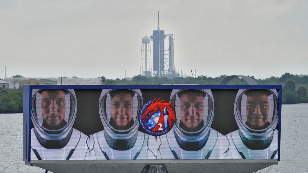 Members of the SpaceX Crew 2, from left, Thomas Pesquet, of the European Space Agency, NASA astronauts Megan McArthur, Shane Kimbrough, and Akihiko Hoshide, of the Japan Aerospace Exploration Agency, are shown on a video screen as the SpaceX Falcon 9 with the crew Dragon capsule sits on Launch Complex 39A Wednesday, April 21, 2021, at the Kennedy Space Center in Cape Canaveral, Fla. Four astronauts will fly on the SpaceX Crew-2 mission to the International Space Station scheduled for launch on April 23, 2021.  (Chris O