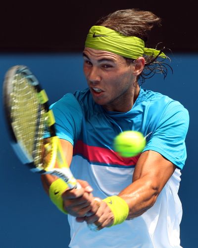 Spain’s Rafael Nadal rips return in his singles victory at Australian Open.  (Associated Press / The Spokesman-Review)