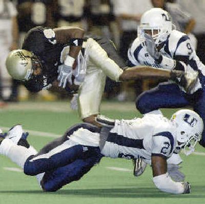 UI's Wendell Octave is upended in the first half.
(Associated Press / The Spokesman-Review)