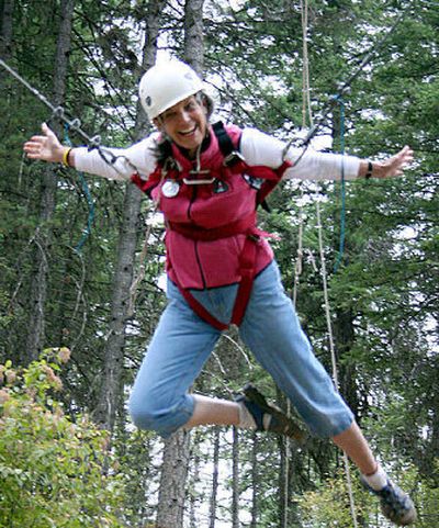 
Gloria Waggoner takes a turn in the giant rope swing at the Women's Retreat at Camp Sweyolakan on Lake Coeur d'Alene. 
 (Photo courtesy of Camp Fire USA / The Spokesman-Review)