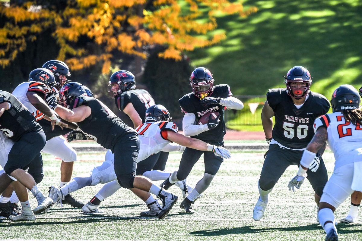 Whitworth RB Solomon Hines tries to hit the hole before Lewis & Clark LB Sam Meinhard (31) can shut it down in the first quarter, Saturday, Oct. 2, 2021, in the Pine Bowl.  (DAN PELLE/THE SPOKESMAN-REVIEW)