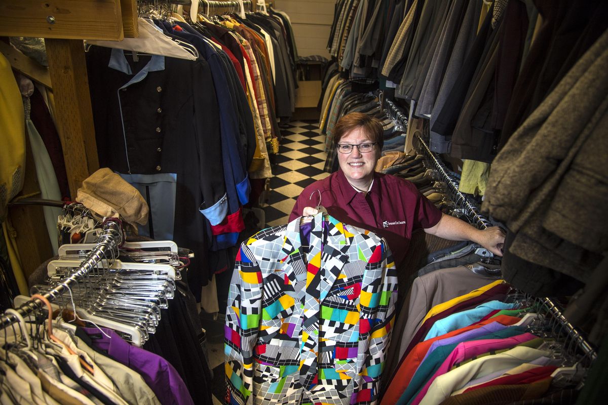 Jan Wanless manages Spokane Civic Theatre’s Rentals Shop, which has more than 10,000 items in its collection, including this multi-colored mens jacket, pants and tie. (Dan Pelle / The Spokesman-Review)