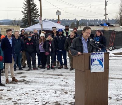 Spokane City Council President Breean Beggs, at podium, gathered outside Camp Hope with other Council members and local organizations to highlight efforts to close Camp Hope and rehouse its residents.   (Photo courtesy of Lisa Gardner)