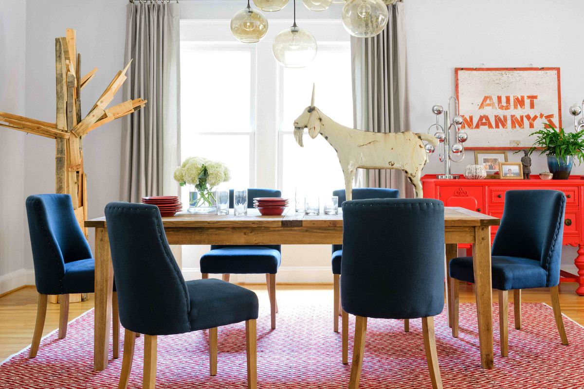 A dining room designed by Brian Patrick Flynn gives folk art a more sophisticated spin by pairing rustic elements with clean tailored accents such as the custom drapery and a soft dove grey wall color. (Associated Press)